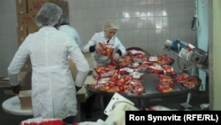 Workers pack the finished product at the Pestova potato-chip factory north of Pristina, one of Kosovo's few production success stories.