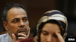 Detained French lecturer Clotilde Reiss (right) and Iranian journalist Ahmad Zeidabadi attend a hearing at a revolutionary court in Tehran on August 8. The United States has criticized the proceedings as "show trials."