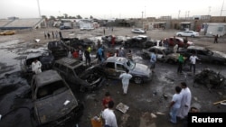 Residents gather at the site of a car bomb attack in Baghdad's Sadr City on May 27. 