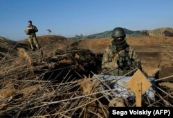 Ukrainian servicemen attend military drills near the village of Urzuf, not far from the city of Mariupol in eastern Ukraine, on November 29. The Ukrainian military is on full combat alert.