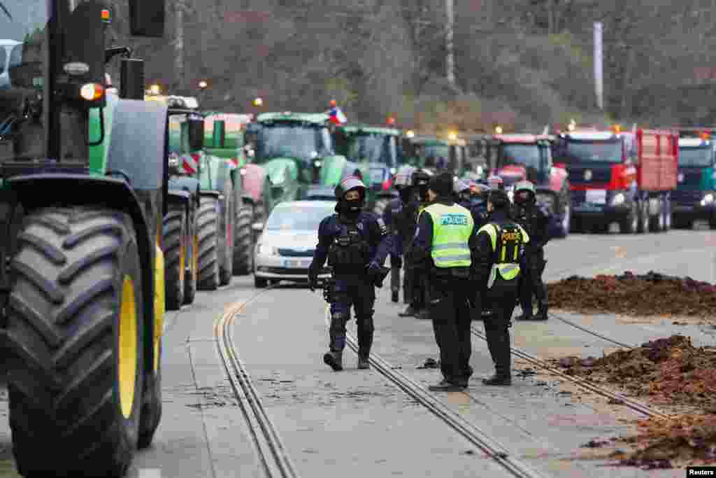 Police in Prague, the Czech Republic, seen alongside piles of manure dumped outside government offices by protesting farmers on March 7.&nbsp; Along with ongoing protests in the Czech Republic, farmers surrounded the European Council building in Brussels in February, and thousands of German farmers shut down major roadways in January.