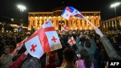 Georgian pro-democracy groups activists protest against a controversial "foreign influence" bill outside the parliament in Tbilisi on April 15. 