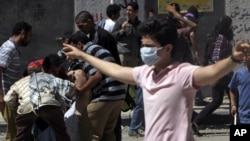 A protester flashes the "V" sign during clashes with security forces in Cairo 