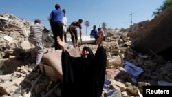 A woman reacts at the site of a suicide bomb attack on a Shi'ite mosque in Mussayab on September 30.