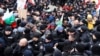 Protesters scuffle with police as they try to enter Bulgaria's parliament building during a rally in Sofia against government measures to curb the spread of the coronavirus on January 12. 