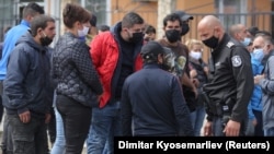 A police officer talks to residents of a Roma district in Sofia in April 2020. Roma had gathered to express concern over losing their jobs due to restrictive coronavirus measures. Roma and people on the move, including refugees and asylum seekers, were placed under discriminatory “forced quarantines” in Bulgaria, Cyprus, France, Greece, Hungary, Russia, Serbia, and Slovakia.