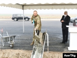 Azerbaijani President Ilham Aliyev symbolically gets work under way on a project to build a railway link in territory near Nagorno-Karabakh on February 14.