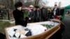 Natalia Magnitskaya (left), mother of Sergei Magnitsky, grieves over her son's body during his funeral at a cemetery in Moscow in November 2009.