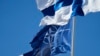 The NATO and Finnish flags flutter over the building of the Foreign Affairs Ministry in Helsinki.