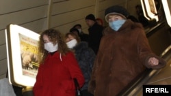 Subway riders in Ukraine wear surgical masks in an effort to protect themselves from swine flu.