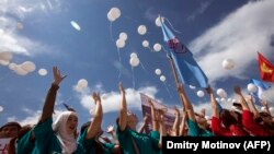 Kyrgyz students release white balloons as they protest against bride kidnapping in downtown Bishkek.