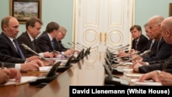 Then-U.S. Vice President Joe Biden (right) meets with then-Russian Prime Minister Vladimir Putin (left) in Moscow on March 10, 2011. Michael McFaul, the architect of President Barack Obama’s Russia “reset,” can be seen at the right rear.