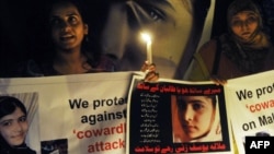 Pakistani activists in Lahore carry candles to pay tribute to gunshot victim Malala Yousafzai and protest against the attempt on her life by the Taliban on October 10.