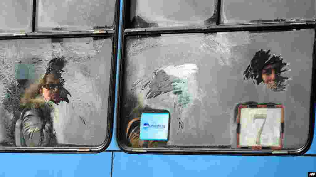 Commuters are seen through an icy window on a tram in central Sofia, Bulgaria.