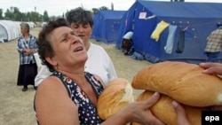 Internally displaced Georgians receive food in a tent camp near Gori earlier this month.