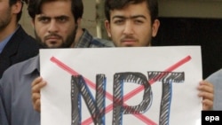 Iranians expressing anti-NPT sentiment at an Islamist-staged protest outside Tehran's presidential palace in October 2003, after Iranian officials indicated they would sign the NPT's "additional protocols." 