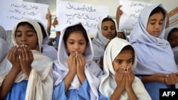 Schoolgirls pray for the recovery of gunshot victim Malala Yousafzai in Multan, in central Pakistan.