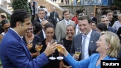 President Mikheil Saakashvili (left) welcomes U.S. Secretary of State Hillary Clinton to Tbilisi on July 5. Suddenly, Georgia's not feeling so isolated.