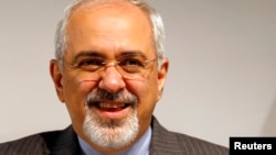 Iranian Foreign Minister Mohammad Javad Zarif smiles during a news conference after nuclear talks at UN European headquarters in Geneva on November 10.