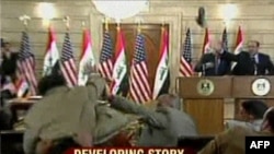 President George W. Bush ducking as Muntadhir al-Zaidi threw his shoes at him on December 14.