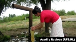 A woman washes clothes in Celebiler.