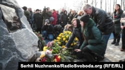 People lay flowers at the new memorial to the victims of Flight PS752 at Boryspil airport.