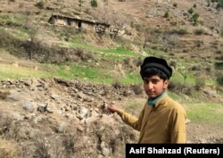 A resident points to the site where Indian jets reportedly struck in Balakot.