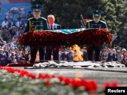 Назарбаев мәңгілік алауға гүл қойып жатыр. Алматы, 9 мамыр 2018 жыл.