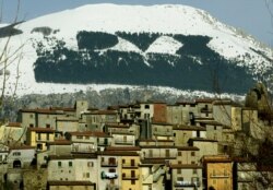 A forest spelling out "DUX" on the side of the Monte Giano mountain.