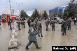 Afghan police keep watch at the site of a suicide attack outside a wedding hall in Kabul on November 16.