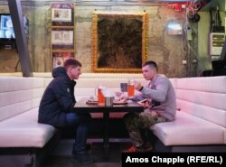 Two locals enjoying a meal of salo-wrapped sushi with beer. The restaurant has been open for seven years.