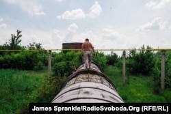 A water pipe that was hit by a mortar in Donetsk in June