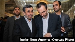 Mahmud Ahmadinejad (left) speaking with his former vice president and close aide Hamid Baghaei (file photo)