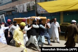 Afghan Sikhs carry the coffin of one of the 19 victims of a suicide attack in Jalalabad.