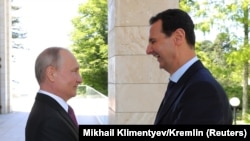 Russian President Vladimir Putin (left) welcomes Syrian President Bashar al-Assad during their meeting in the Black Sea resort of Sochi in May.