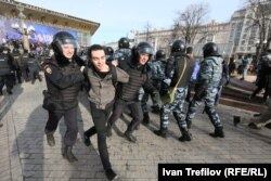 Police haul away protesters at demonstrations in Moscow on March 26.