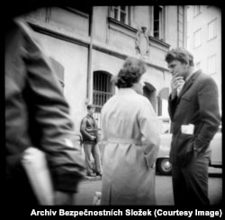 Czechoslovak author Milan Kundera (right) speaks with an associate. A 2008 book called Prague Through The Lens Of The Secret Police – from which many of these images are sourced -- identifies the leather-jacketed man in background as an agent operating a camera hidden in his suitcase. The spy cameras could be triggered with a thin cable, allowing pictures to be taken without touching the device itself.