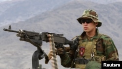 A Special Forces member from the Afghan National Army mans a machine gun on an armored vehicle while leaving for a mission with U.S. Special Forces soldiers in Kunar Province on March 12.