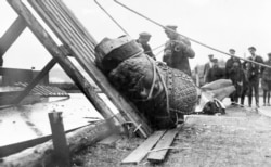 The head from a statue of Russian Tsar Alexander III being torn down after the Bolshevik Revolution.