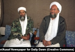 Zawahri (right) sits beside Osama bin Laden in November 2001.