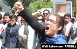 An Afghan woman shouts during a demonstration against President Ashraf Ghani's government on June 2.