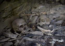 Human skulls and other bones inside the huts, known as the Anatori burial vaults.