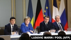 Ukrainian President Volodymyr Zelenskiy (left to right), German Chancellor Angela Merkel, French President Emmanuel Macron, and Russian President Vladimir Putin attend a joint news conference after a Normandy Format summit in Paris in December 2019.