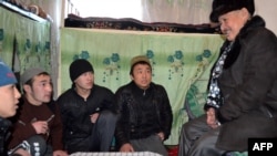 Kyrgyz ombudsman Tursunbek Akun (right) speaks with prisoners during a visit to a prison in Osh on January 20.