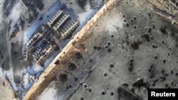 Aerial footage shot by a drone shows shell craters from intense fighting at Donetsk's international airport.