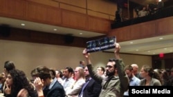 Student Ali Abdi holds a “End Sanctions Against Iran” sign at an event in New York where Iranian Foreign Minister Mohammad Javad Zarif was speaking.