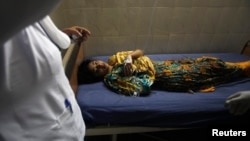 A young girl who was injured in the April 29 attack on University Road waits for treatment at a hospital in Peshawar.