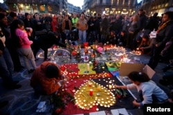 People gather around an impromptu memorial in Brussels to pay tribute to the victims of the bombing attacks.