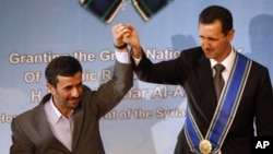 The fall of Bashar al-Assad (right ) would be a "disaster" for Iran and President Mahmud Ahmadinejad.