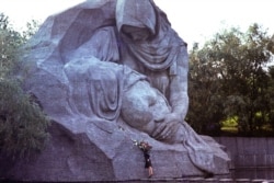 A woman lays flowers at the World War II memorial complex in Volgograd, Russia.